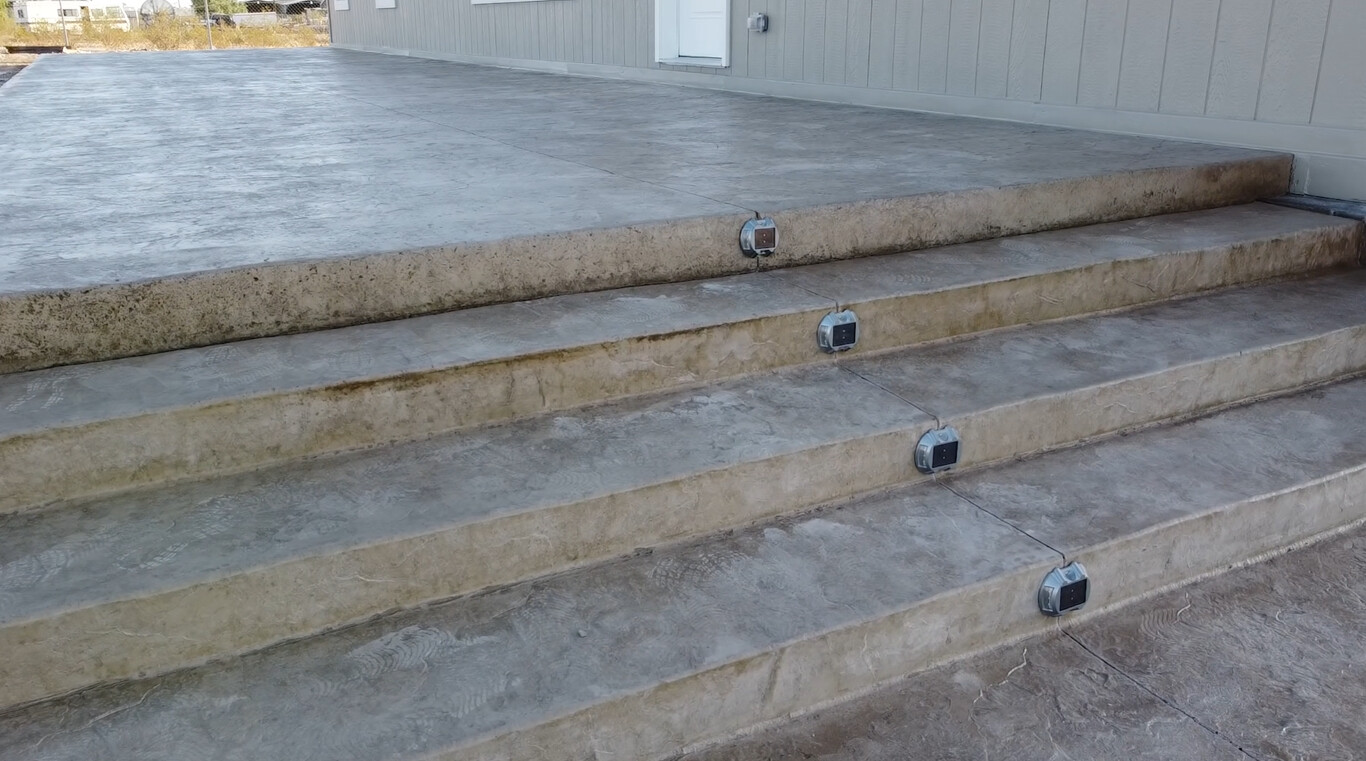 Stamped concrete steps and raised deck area with durable slip-resistant finish for outdoor use